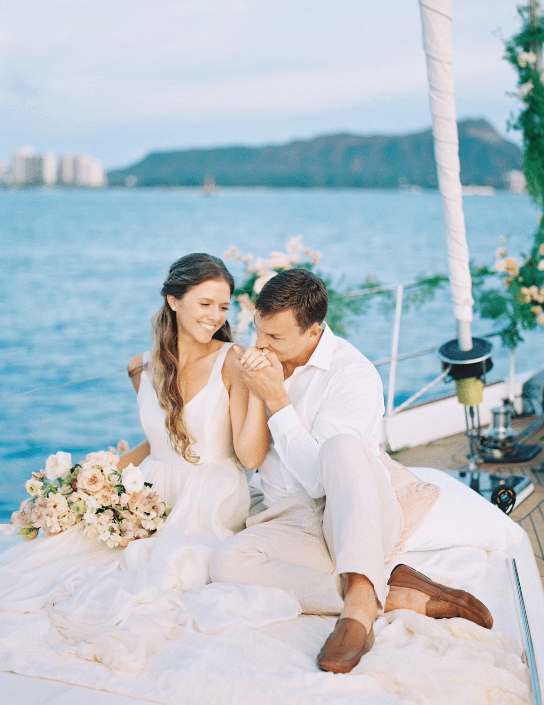 bride and groom on a sail boat having a Sailing elopement